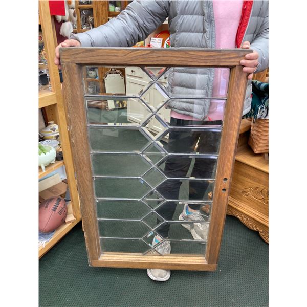 ANTIQUE WOODEN-FRAMED WINDOW FEATURING A BEVELED GLASS DESIGN