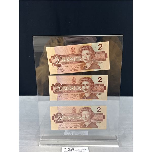 3 Uncirculated 1986 $2 Dollar Canadian Bills in Display Stand