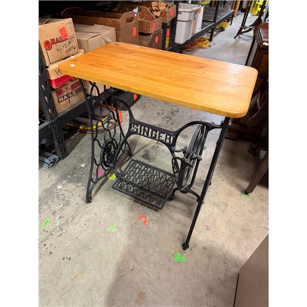 Singer, sewing machine base table measures 26" x 15 and three-quarter inches and 29 inches tall