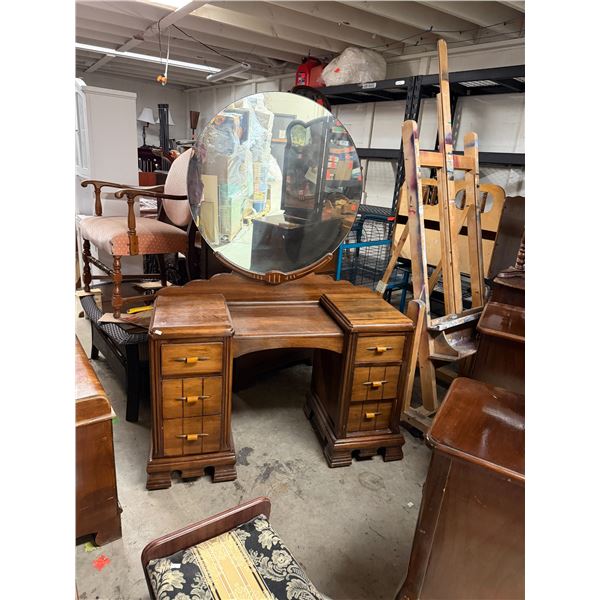 Art Deco waterfall vanity made of walnut with a large circular mirror and bakelite scalloped drawer 