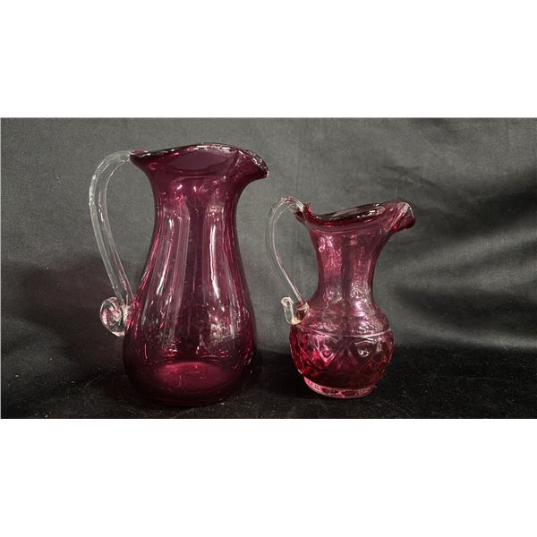 2 CRANBERRY GLASS PITCHERS WITH CLEAR GLASS HANDLES: TALLEST IS 6.5" TALL