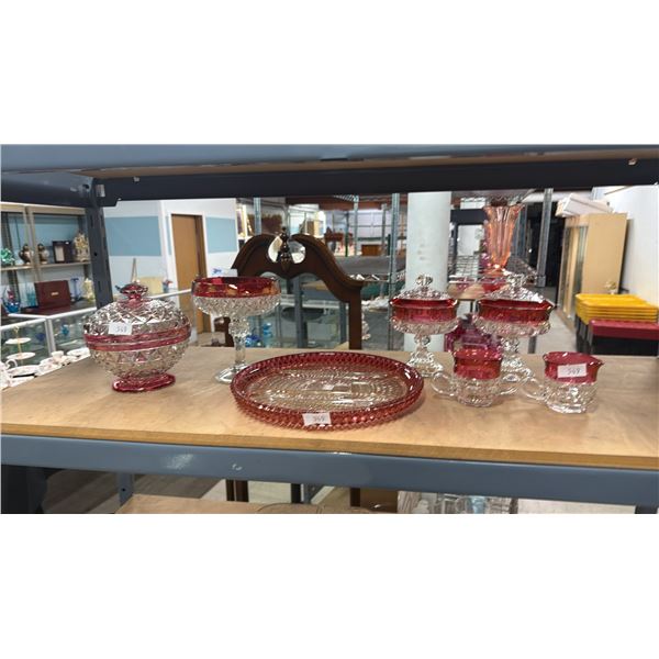 SHELF OF ASSORTED GLASSWARE WITH CRANBERRY ACCENTS: CRUDITE DISH, CREAM & SUGAR, CANDY DISHES & MORE