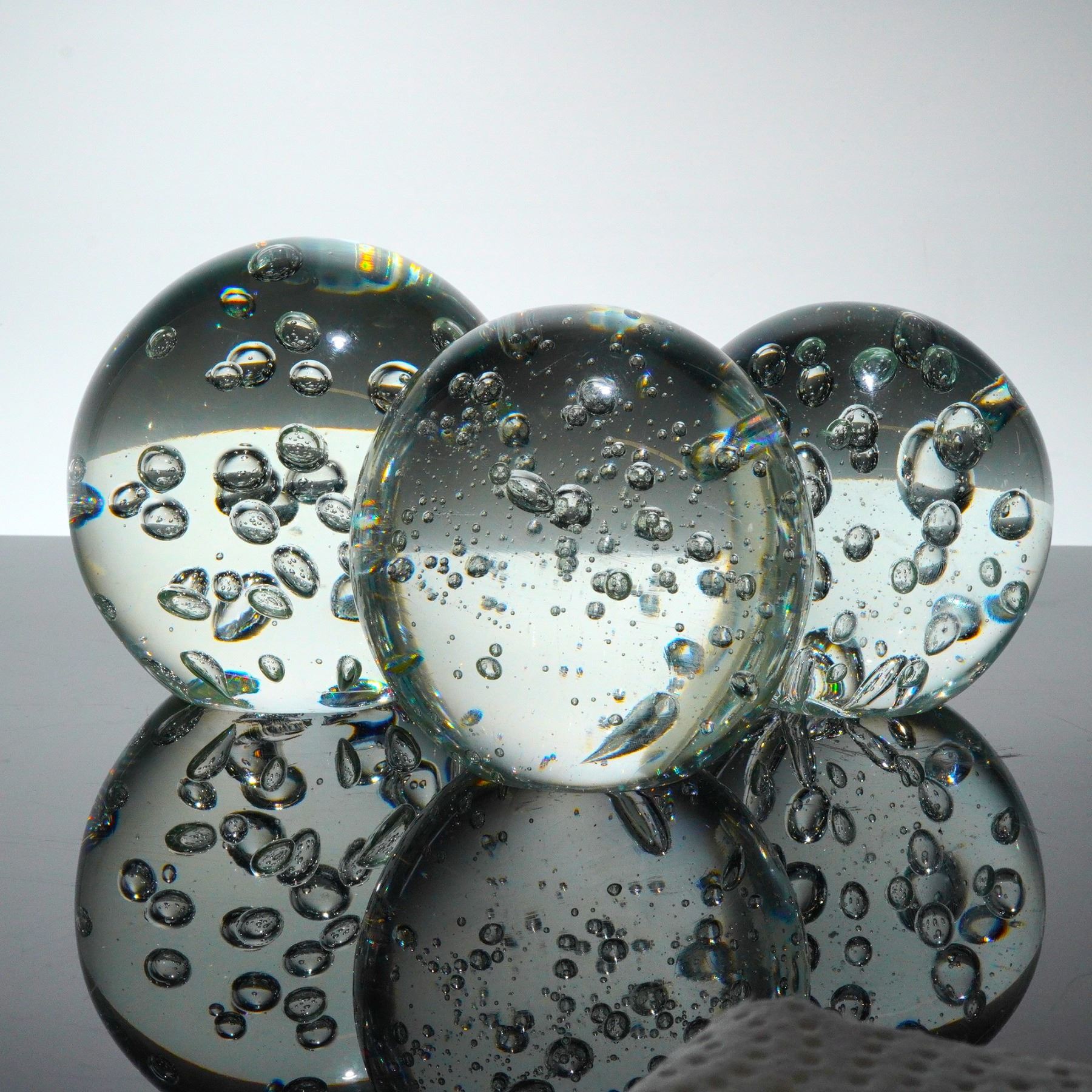 Three Clear Glass Spheres with Controlled Bubble Inclusions