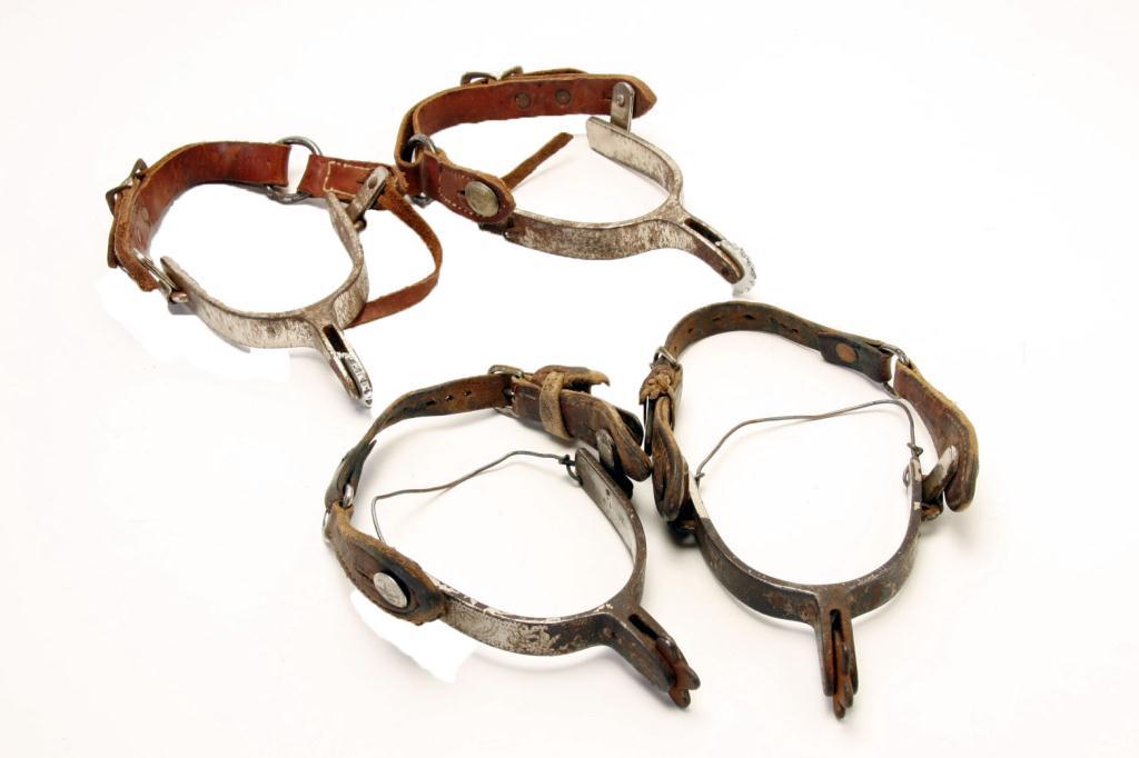 Collection of 2 Rustic Crockett Spurs with spur straps.