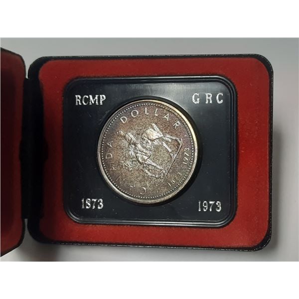 1873 – 1973 Centennial of the RCMP Silver Dollar. Specimen. Beautifully Toned. Housed in it