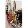 Image 1 : Multiple Cleaning Tools: Hose, Mops, Caution Signs, etc