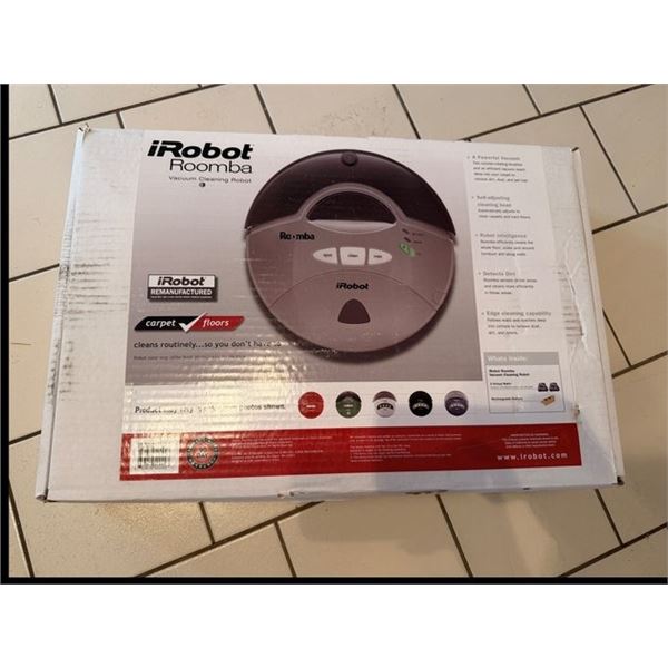 ROOMBA IROBOT VACUUM CLEANING ROBOT. SHOWN WORKING