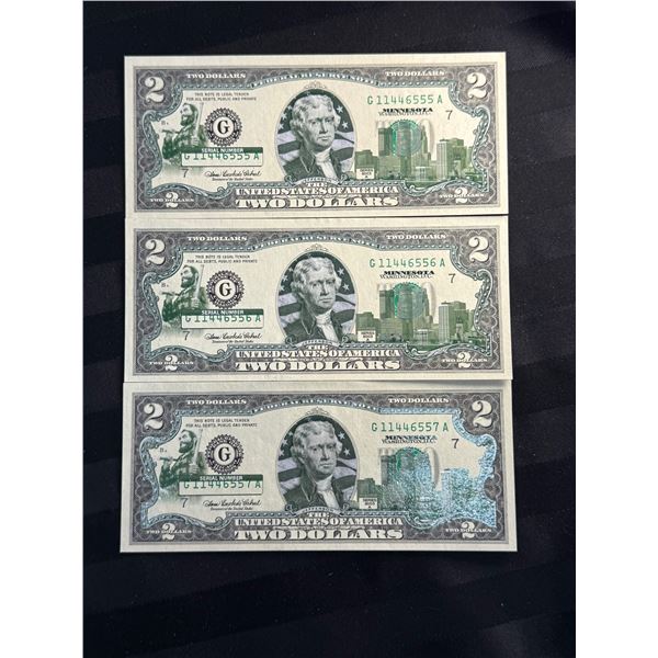 UNCIRCULATED SERIES 2003 $2 BILLS THAT HAVE BEEN COLORIZED WITH MINNESOTA-SPECIFIC OVERLAY; LOT OF 3