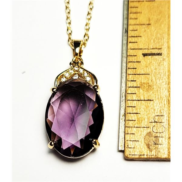 19)  GOLD TONE WITH AMETHYST COLORED