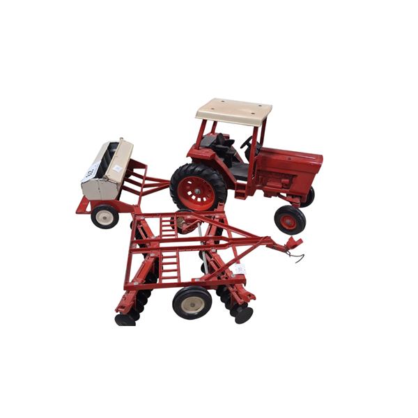 Vintage die cast tractor toy with two impliments, tractor is 10"