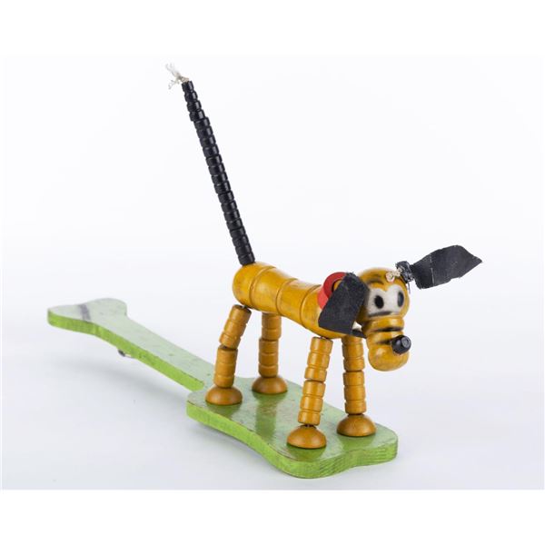 A 1936 Fisher Price Pop Up Kritter Pluto Toy.