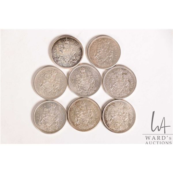 Eight Canadian 50 cent coins including 1960, 1962, two 1963, 1964, 1965, and 1966