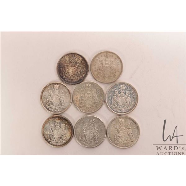 Eight Canadian fifty cent coins including 1964 and seven 1966