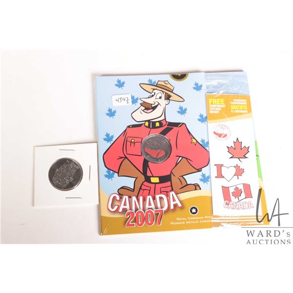 Canadian 2007 collector Mounted Police Force quarter and a Canadian 1952-2002 50 cent piece