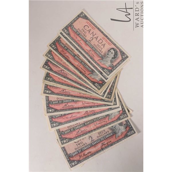 Thirteen 1954 Bank of Canada $2 bills in circulated to heavily circulated condition