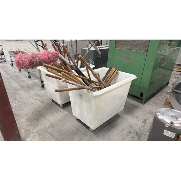 WHITE PLASTIC MOBILE BIN FILLED WITH ASSORTED BROOMS, SHOVELS. ETC