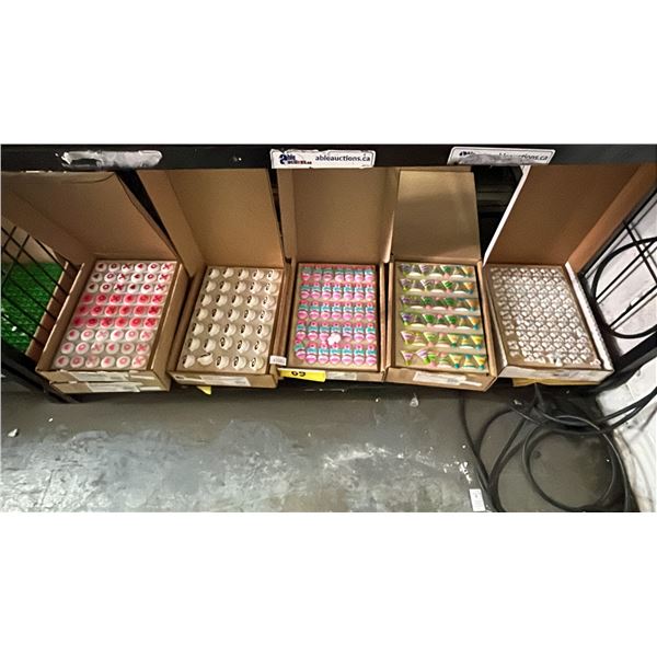 SHELF OF ASSORTED LUCK'S DEC-ONS SUGAR DECORATIONS: COFFEE CUPS, BABY RATTLES, PARTY HATS & MORE