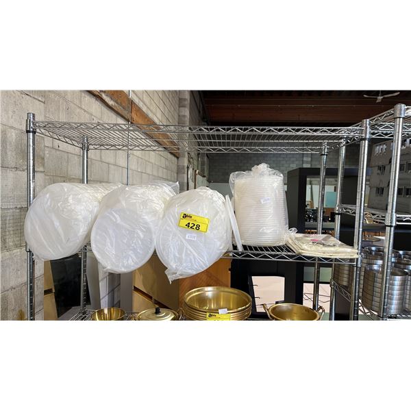 SHELF OF PLASTIC TABLECLOTHS & PLASTIC LIDS