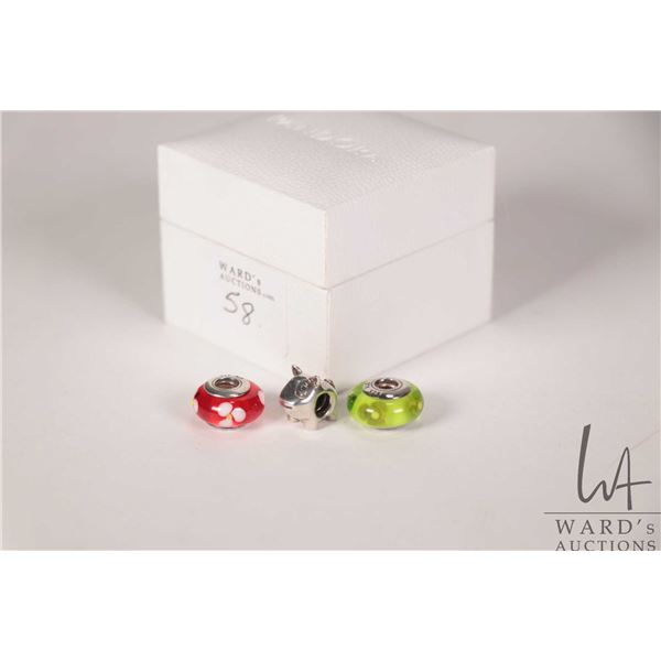 Three genuine Pandora beads including two Murano glass beads and a sterling silver dog, all marked P