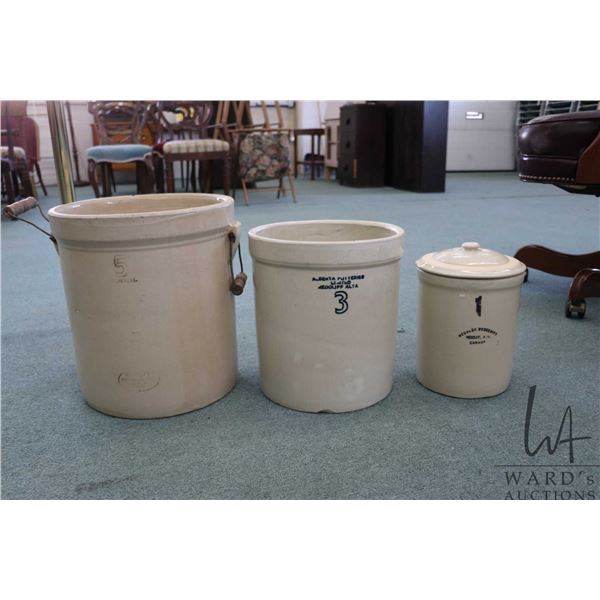 Three stoneware crocks including five gallon Medalta Potteries with handles, three gallon Alberta Po