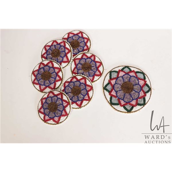 Seven Indigenous beaded mats including six 3 1/2" and a 4 3/4"