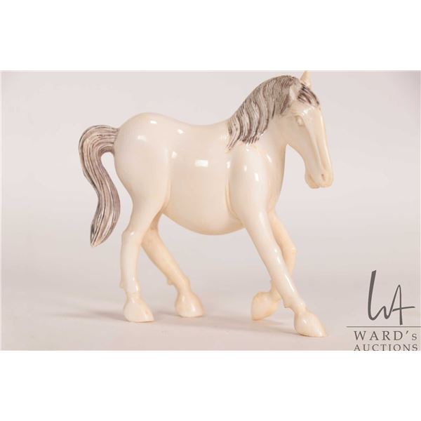 Hand carved elephant ivory miniature horse, 2 3/4" in height. Can not be shipped outside of Canada. 