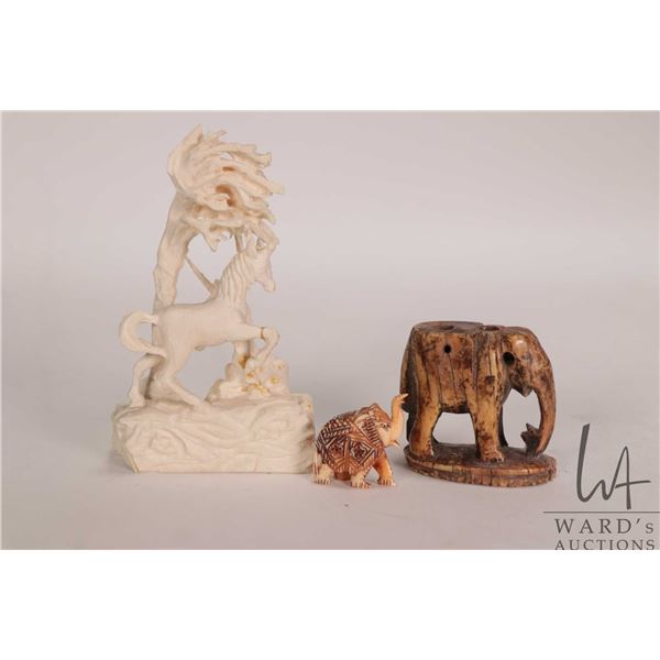 Three small carvings including ivory unicorn figures, note: has been glued 4" in height and a 1" ele