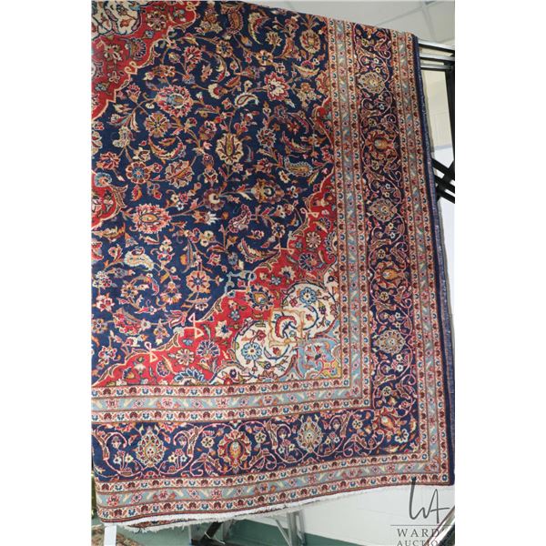 Iranian wool carpet "Kashan' with center medallion on blue background with overall floral design and