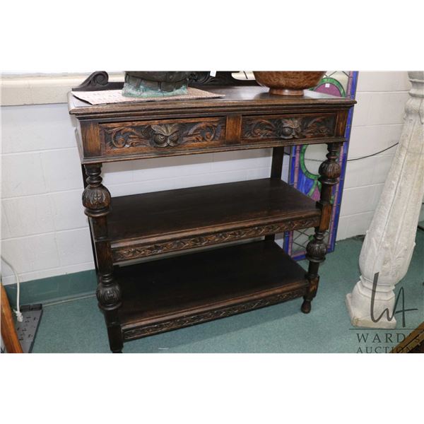 Antique European quarter cut oak server with two tiered base and two carved front drawers featuring 