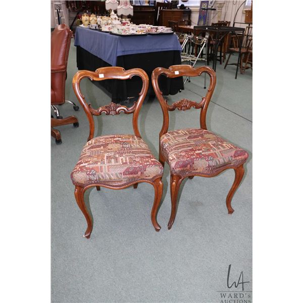 Pair of antique Victorian balloon back chairs with curved supports, carved back and upholstered seat