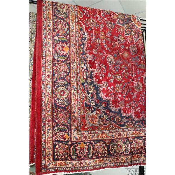 Iranian wool carpet "Mashad" with center medallion on red background and highlights of orange, green