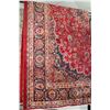 Image 1 : Iranian wool carpet "Mashad" with center medallion on red background and highlights of orange, green