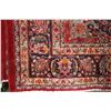 Image 2 : Iranian wool carpet "Mashad" with center medallion on red background and highlights of orange, green