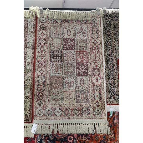 Small scatter rug with geometric tile pattern. 25" X 40"