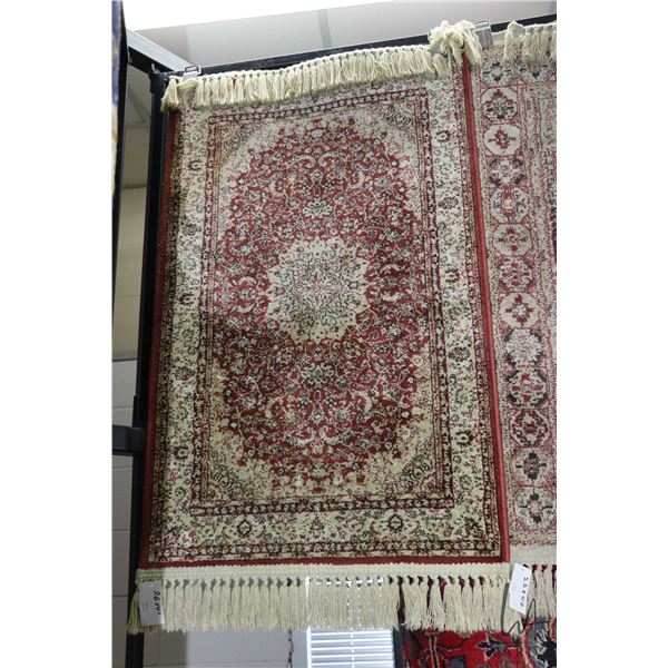Small scatter rug with center medallion and fringed edging 26" X 41"