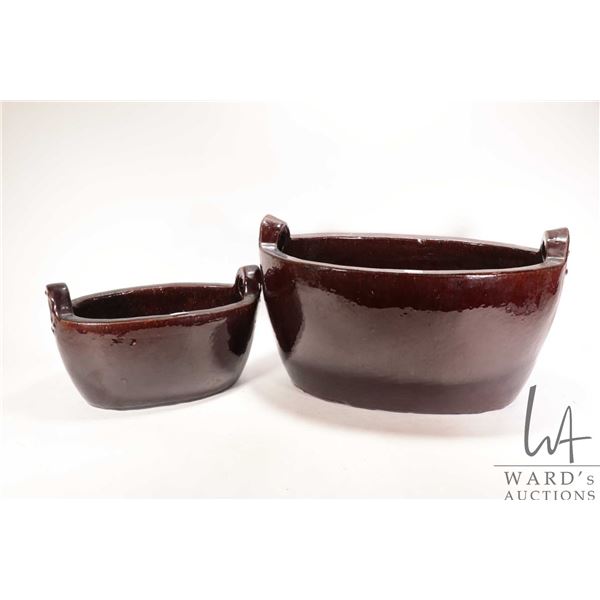 Two oval outdoor glazed pottery planters, one measuring 20" wide x 10" deep, and 14" wide and 6-1/2"