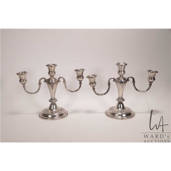 A pair of Birks Sterling weighted two branch candelabras, note damage to finish and arms