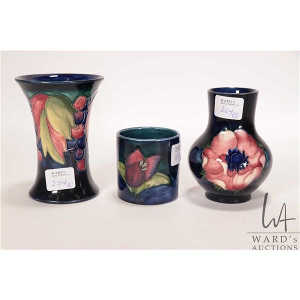 Three vintage Moorcroft vases including "Leaf and Berry" 4 1/2" spill vase, small "Anemone" baluster