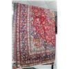 Image 1 : Iranian wool carpet "Mashad" with center medallion on red background and highlights of blues, taupe,