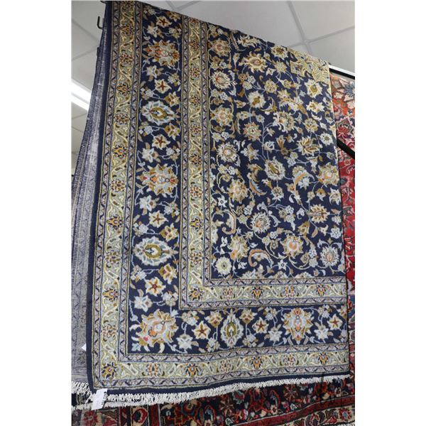 Iranian wool carpet "Kashan" with center medallion on blue background with overall floral design and