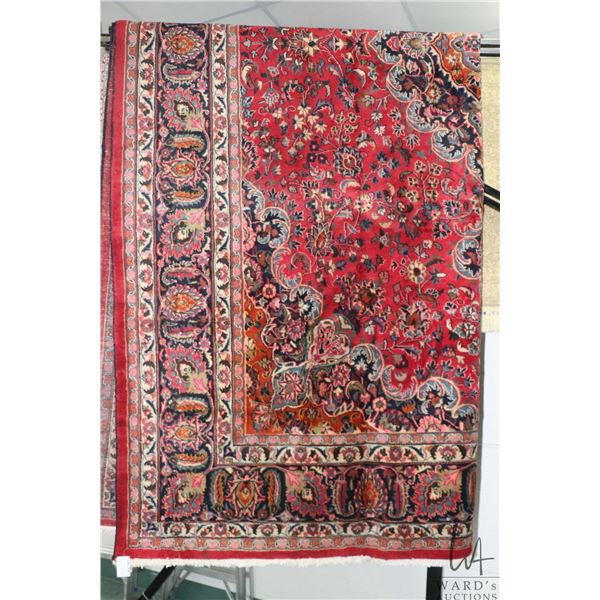 Iranian wool carpet "Kashad with center medallion on red background with overall floral design and h