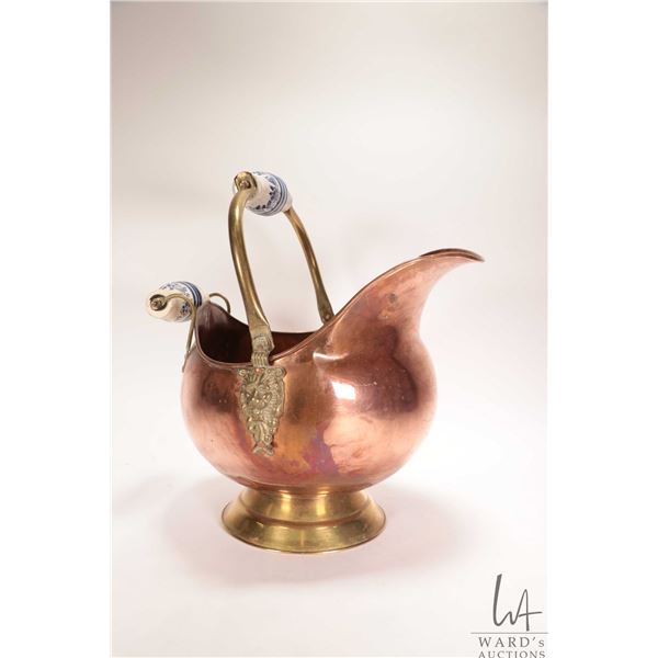 Vintage copper and brass coal scuttle with double lion head brass, and porcelain handles