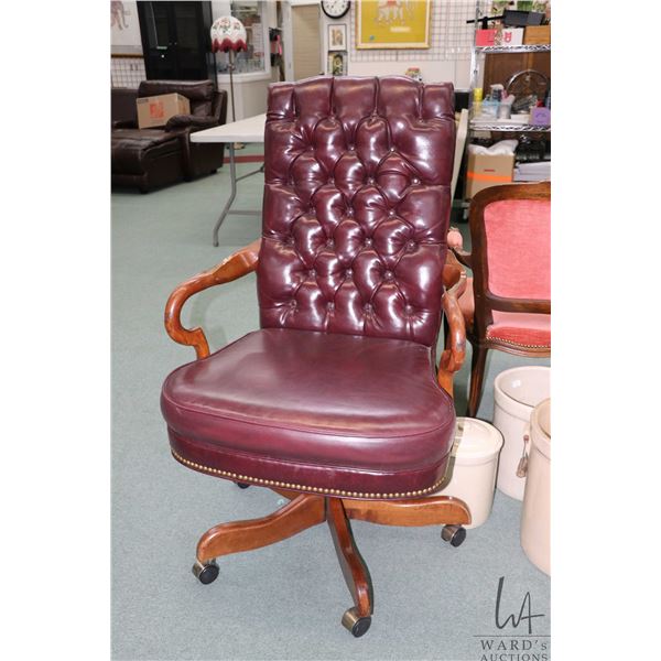 Quality tufted oxblood leather swivel office chair with wooden goose neck arms and five castor base