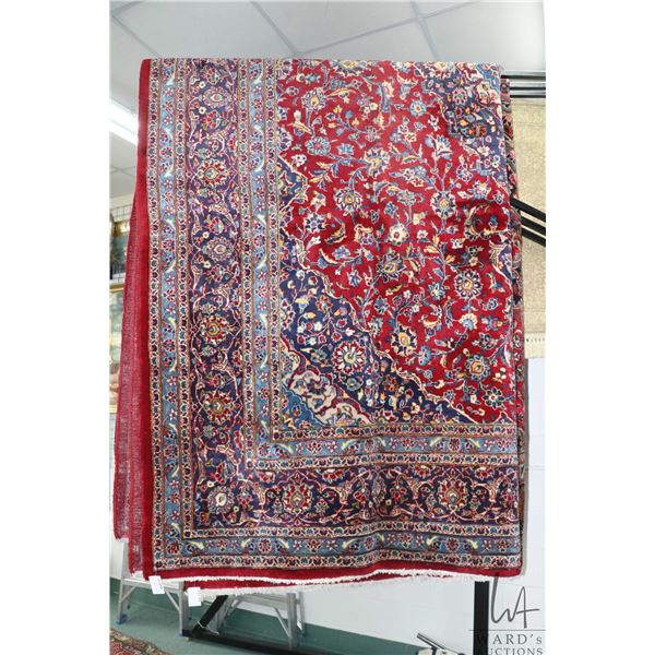 Iranian wool carpet "Mashad" with center medallion on red background, overall floral design and high
