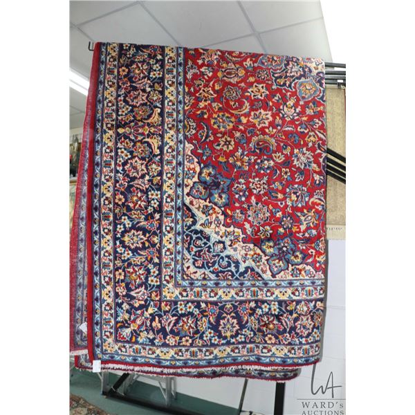 Iranian wool carpet "Esfahan" with center medallion, red background, overall floral design and highl