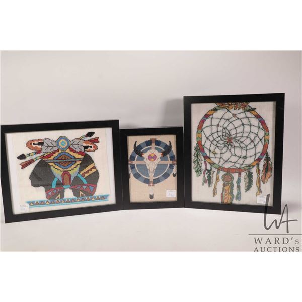 Three small Indigenous theme needleworks including dream catcher 11" X 9", bear 9" X 11" and a buffa