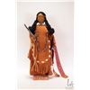 Image 1 : Mrs. B The Dollmarker, hand made doll in buck skin clothing on wooden plinth, dated 1993, 16" in hei