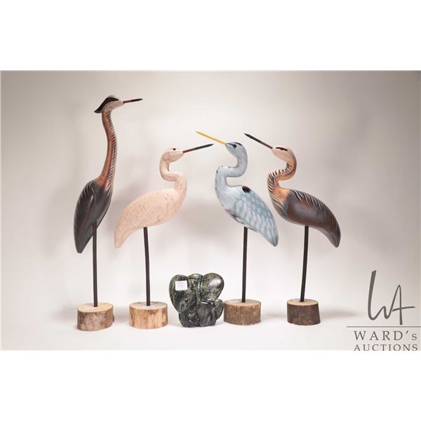 Four wooden carved cranes, ranging from 15"-21" in height plus a carved Zimbabwe stone elephant and 