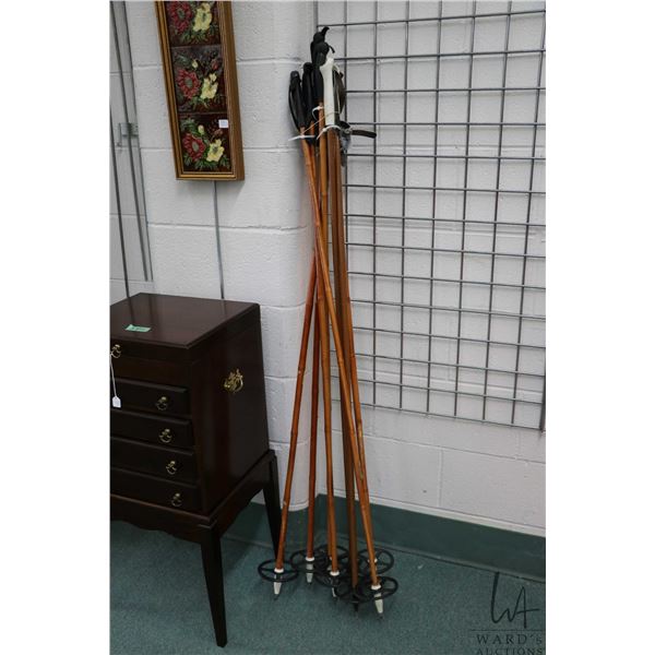 Three pairs of bamboo and one pair of fiberglass ski poles