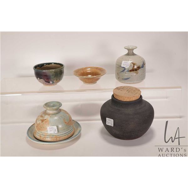 Five pieces of artisan pottery including lidded pot, bowls, bud vase, cheese dome etc.